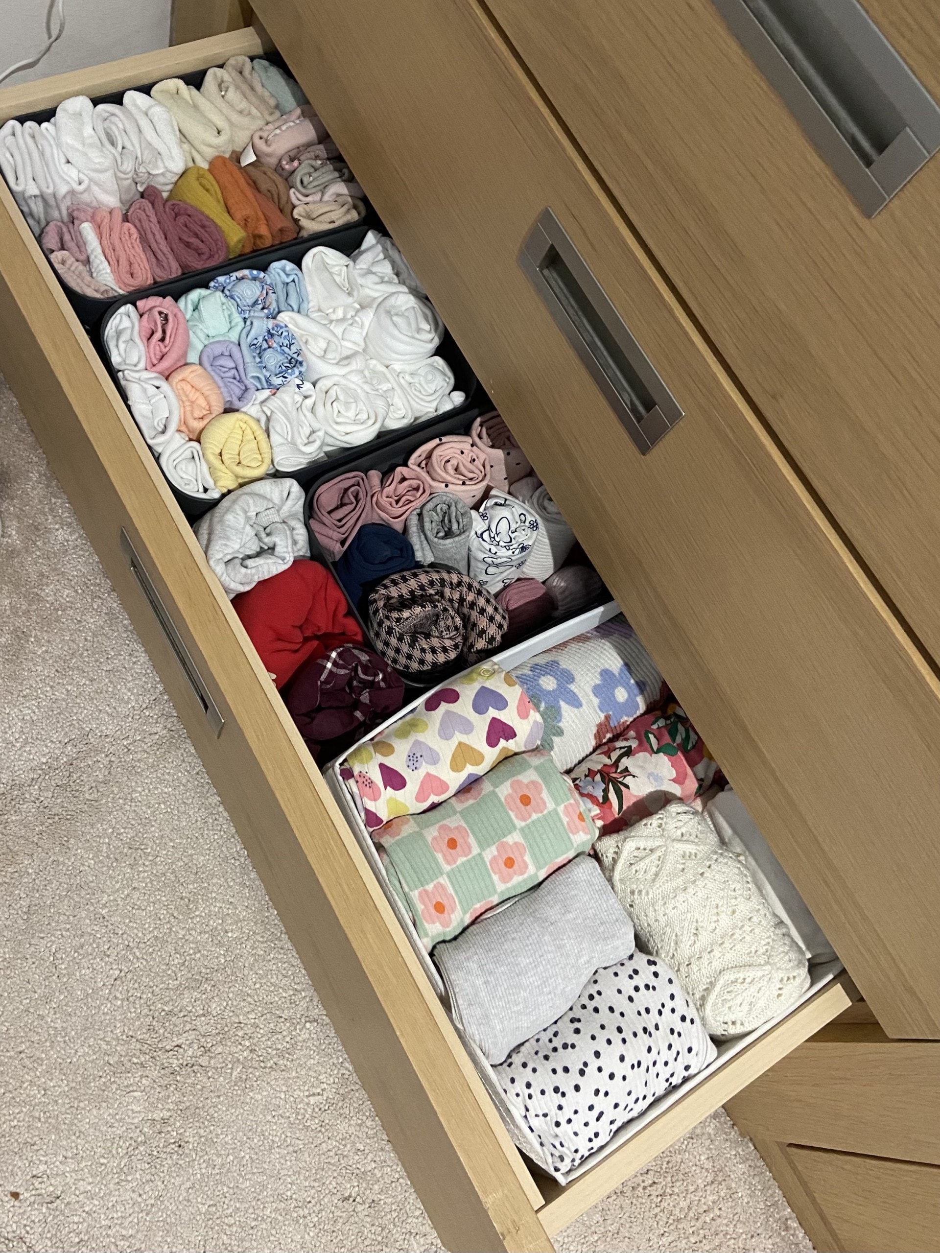 Neatly organised drawer with folded clothes